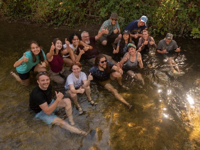Group of students gathered in a river