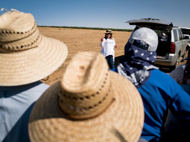 Educator working with people in a field