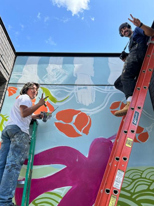 Students help paint a mural in Chico, CA.