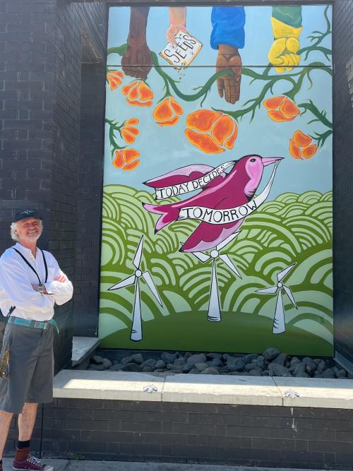 Man standing in front of mural