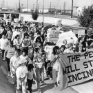 Peopl marching with a sign to "Stop the Incinerator"